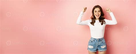She Is A Winner Enthusiastic Brunette Girl Celebrating Jumping From She Is A Winner Enthusiastic Brunette Girl Celebrating Jumping From
