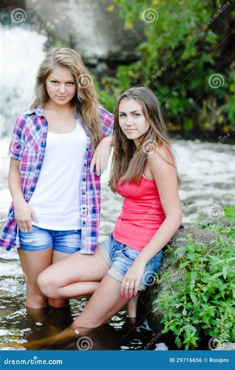 Two Teen Girls And Summer Outdoors Near Waterfall Stock Photo And Two Teen Girls And Summer Outdoors Near Waterfall Stock Photo And